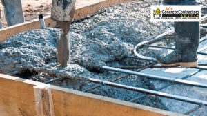 Contractor pouring a concrete mix to reinforced foundation