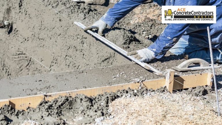 A concrete contractor is using a tool to level the concrete mixture