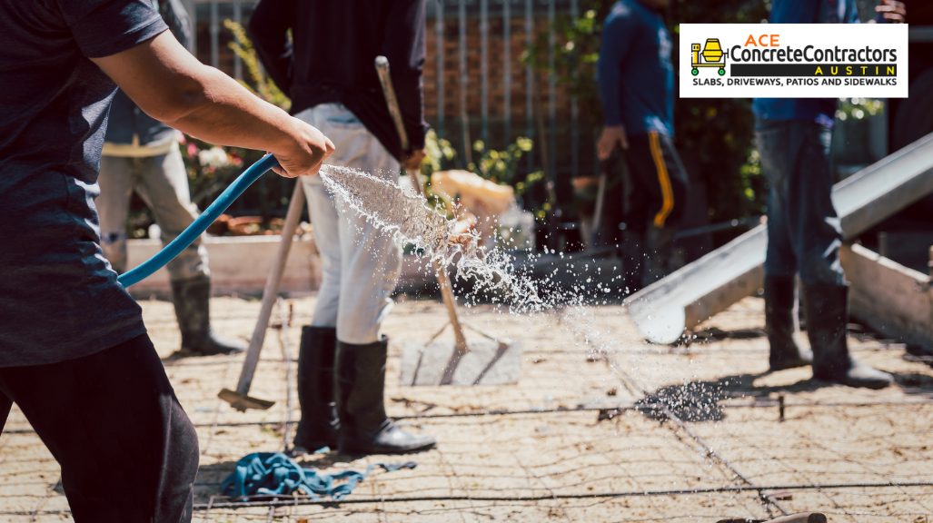 person watering dry concrete