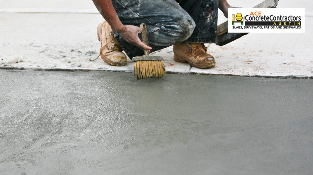 person brushing wet concrete surface