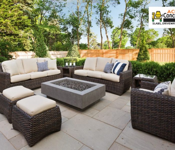 rattan lounge chair set and table on concrete patio