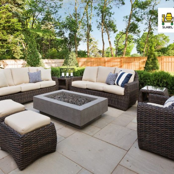 rattan lounge chair set and table on concrete patio
