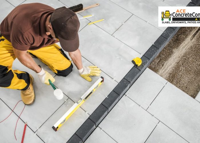 person leveling concrete patio