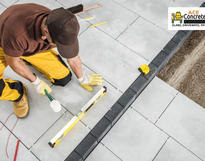 person leveling concrete patio