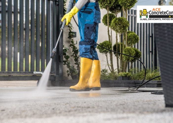 person cleaning driveway