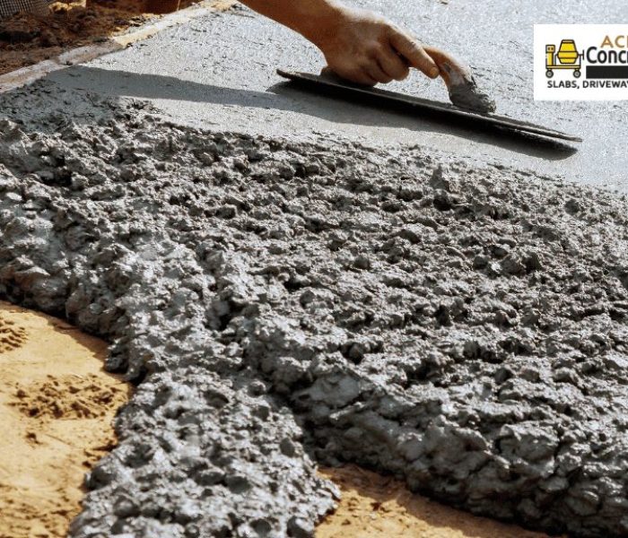Concrete contractor using a hand float to finish a wet slab