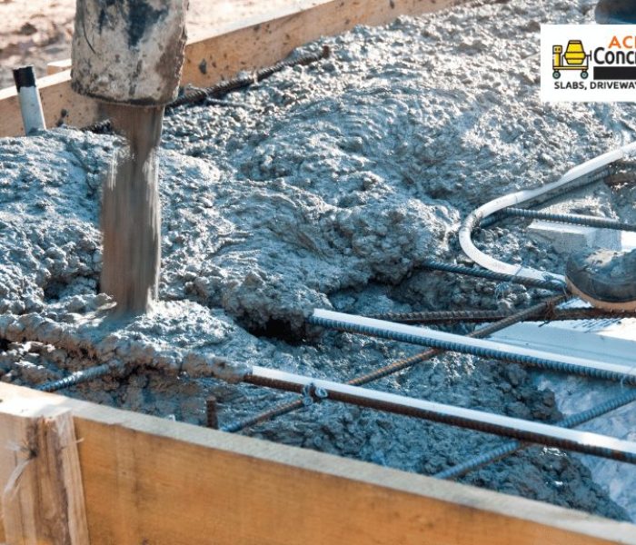 Contractor pouring a concrete mix to reinforced foundation